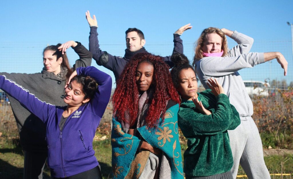 A group of diverse young people vogue for the camera